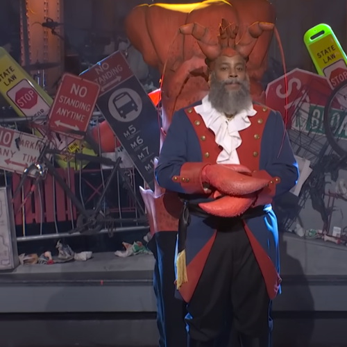 A black male dressed as a lobster in SNL New York 50th Musical